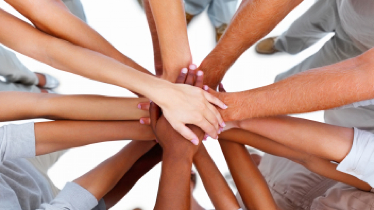 Business people standing with hands together